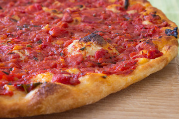 Homemade pizza with organic tomato and extra virgin olive oil