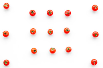 Fresh red tomatoes scattered on white background top view pattern