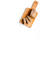 Homemade fresh bread sliced on cutting board on white background top view copy space