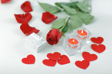 Fototapeta na wymiar romantic concept .gift box, burning candle and red rose . photo with copy space