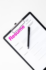 Looking for work concept. Resume on padwith on white background top view space for text