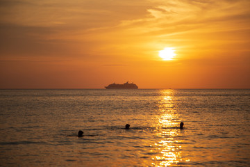 Cruise liner on the horizon against the setting sun