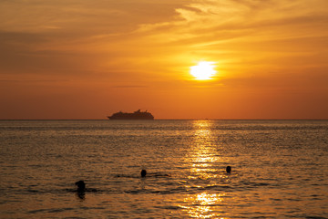 Cruise liner on the horizon against the setting sun