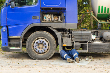 Repair of a broken truck car on the road from mechanic, truck driver