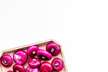 Red onion is healthy product. Onion bulbs in tray on white background top view space for text