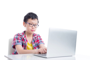 Young asian boy wearing headset and using laptop computer over white background