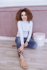 Curly girl with freckles in an empty white sweatshirt. Layout.