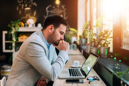 Thoughtful Businessman Looking At Laptop Screen.