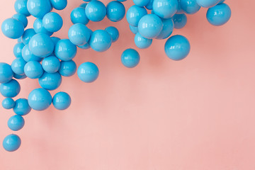 Bunch of blue balloons, blue bubbles on pink background flying up. Modern punchy pastel colors