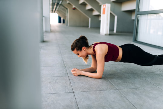 Close up image of fit girl doing plank.