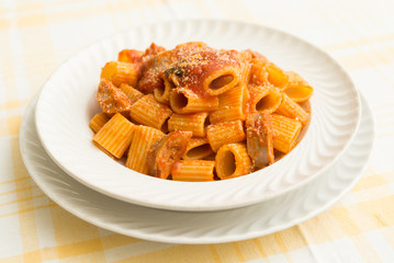 Mezze maniche, dish of italian pasta with meat, tomato sauce and cheese