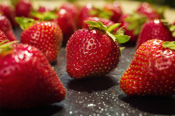 strawberries on stone background, delicious first class organic fruit as a concept of summer vitamins