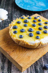 Blueberry cheesecake without baking on a blue plate side view