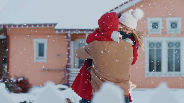 Beautiful Young Woman Returns Home, Her Husband Meets Her with the Open Arms, They Embrace, and Spin - Hug. Young Couple in Love. Shot on RED EPIC-W 8K Helium Cinema Camera.