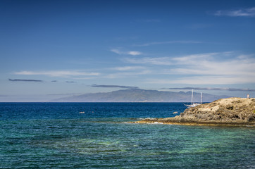A yacht sailing out of the port