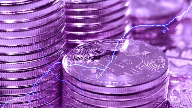 Blockchain technology, Bitcoins mining concept in violet style with lightning, macro shot of bitcoins. Cryptocurrency Bitcoin, BTC, power consumption concept
