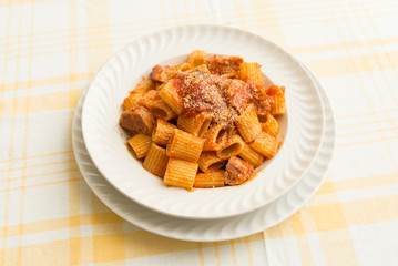 Mezze maniche, dish of italian pasta with meat, tomato sauce and cheese