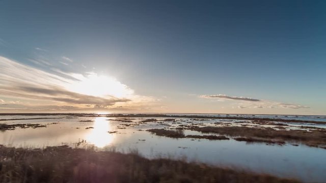 pov shot with a camera attached to the front of an off road vehicle driving along a small road in the delta d'ebro park, spain