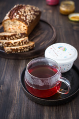 Banana cake with seeds and a cup of hot tea