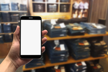 holding the mobile phone on a blurry background.