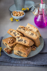 On a plate of mannik with walnuts. Blondie. In pieces. Decorated with mimosa flowers