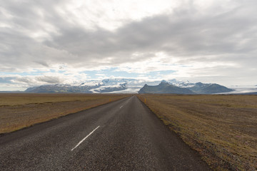 Fototapeta na wymiar Travel to Iceland. Spectacular Icelandic landscape with road and scenic nature- fjords, fields, clouds. Driving the Ring Road in Southeast Iceland