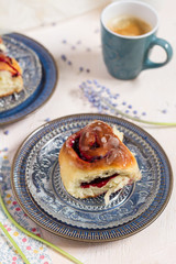 Blackberries buns. White background and blue plates. Coffee and flowers.