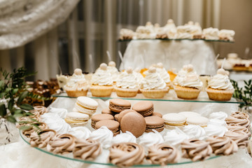 Dessert table for a party. Ombre cake, cupcakes, sweetness and f