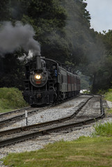 Fototapeta na wymiar Steam Engine with Passenger Train Pulling into Station pt 2