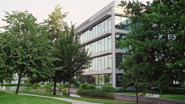 Modern office building in the city park. View of a business quarter on summer