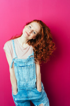 Young cheerful woman wearing overalls