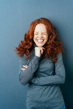 Portrait of young laughing red-haired woman