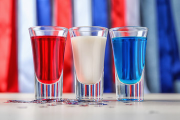 Cocktails in colors of American flag on wooden table