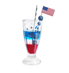 Layered cocktail in colors of American flag on white background