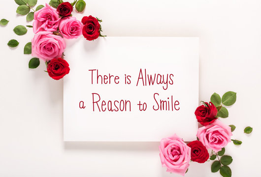 There Is Always A Reason to Smile message with roses and leaves top view flat lay