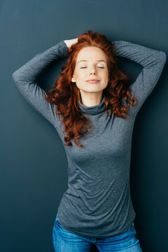 Serene attractive young redhead woman