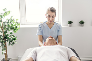 Patient at the physiotherapy doing physical exercises with his therapist
