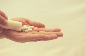 Tablets with a package in the palm of a close-up.