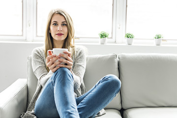 Young woman on a sofa on the living room