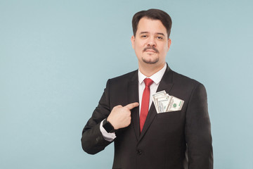 Businessman pointing finger at himself money in the pocket
