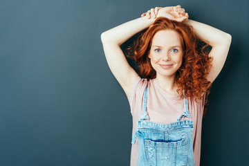 Happy friendly cute young woman in dungarees