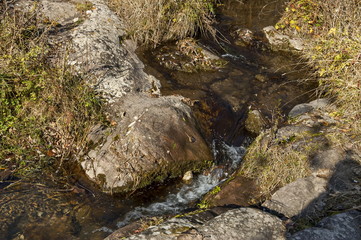 Autumnal view of  river Lokorska in stone riverside, Balkan mountain, near village Lokorsko, Bulgaria 