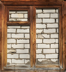 wooden window frame walled with bricks