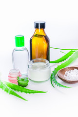 aloe vera gel and rock salt minerals skin cream on white background. organic skin care and natural cosmetic for sensitive skin. sliced aloe vera leaf. alternative medicine, spa and skin care concept.