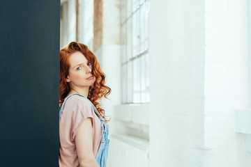Fototapeta premium Thoughtful attractive young woman with red hair