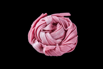 Pink pasta on a black background