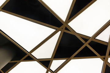The bottom view of the modern white triangular ceiling