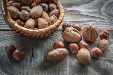 Healthy mix nuts on wooden background. Walnut, hazelnut, almond and pecan. Selective focus. Close up.