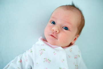 Cute two week old baby girl in cradle