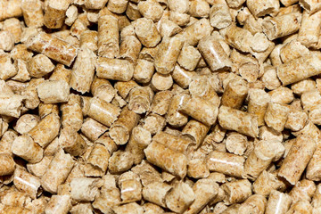 Biofuels. Alternative biofuel from sawdust. Wood pellets background. The cat litter.